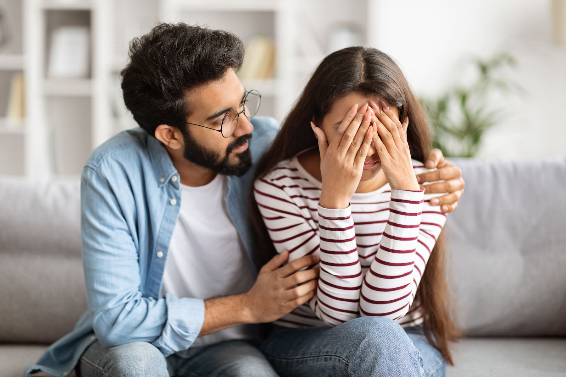 Man consoling woman